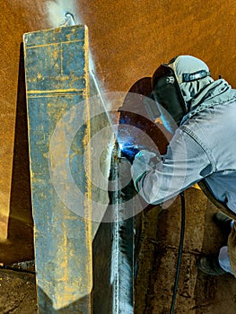 Welder working with an electrode. Welding work.