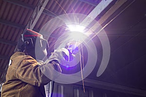 Welder working in a factory