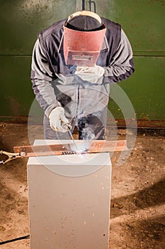 Welder working factory welding the metal