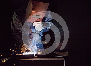 Welder working factory welding the metal