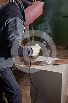 Welder working factory welding the metal