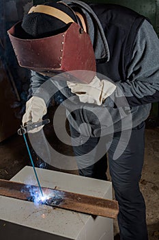 Welder working factory welding the metal