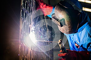 Welder working in industrial factory