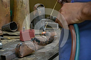 Welder working on iron to make cowbell