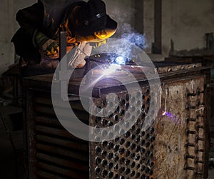 Welder working with metal