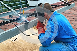 Welder working with metal construction