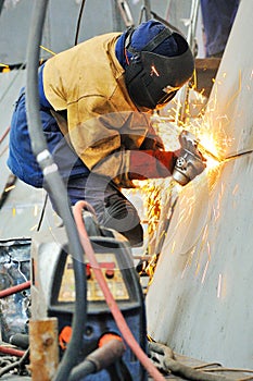 Welder working at shipyard in day time