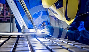 Welder working in a steel factory with argon welding