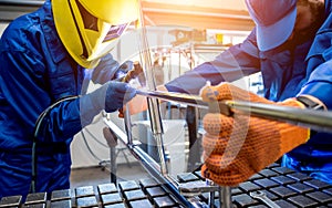 Welder working in a steel factory with argon welding