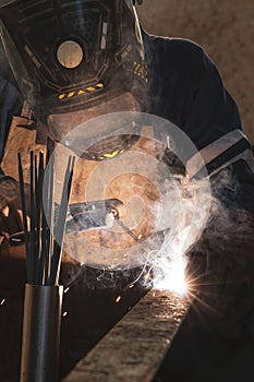 Welder working in their workshop while wearing a faceguard