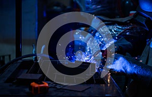 A welder is working to weld metal. to create quality work according