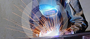 Welder works in an industrial company - production of steel comp