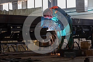 welder works in Industrial workshop - construction and processing of steel component