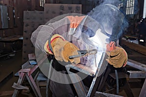 Welder in workshop conditions sample weld from sheet metal to un