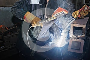 Welder in workshop conditions sample weld from sheet metal to un