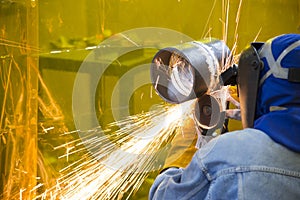 The welding craftsman grinding the steel tube