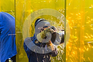 The welding craftsman grinding the steel tube