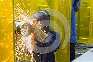 The welding craftsman grinding the steel tube