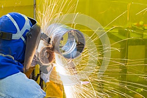 The welding craftsman grinding the steel tube