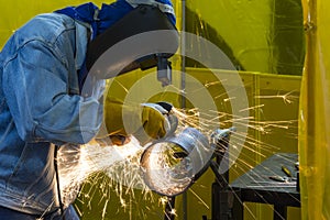 The welding craftsman grinding the steel tube