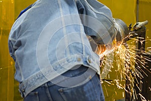 The welding craftsman grinding the steel tube