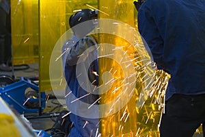 The welding craftsman grinding the steel tube