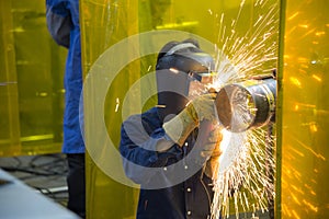 The welding craftsman grinding the steel tube