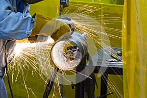 The welding craftsman grinding the steel tube