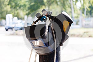 Welding equipment, helmet hanging on a gas cylinder, two welder masks. there are no people