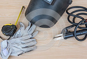 Welding head and protective equipment in industrial metal steel on wood background