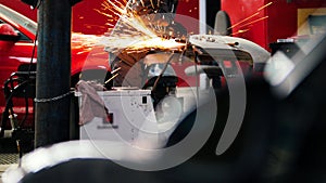 Welding industrial: worker in helmet repair detail in car auto service