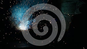 Welding of metal parts, a lot of sparks and smoke, close-up, industry, slo-mo,