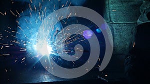 Welding of metal parts, a lot of sparks and smoke, close-up, industry, slo-mo,