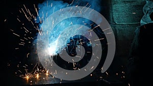 Welding of metal parts, a lot of sparks and smoke, close-up, industry, slo-mo,