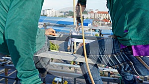 Welding of metal structures with soldering steel beam structure on extension of a building on construction site. Sparks and smoke