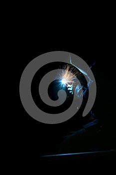 Welding with a MIG in the dark photo
