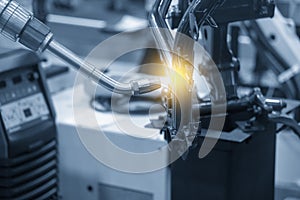 The welding robot working with motorcycle parts assembly processing.