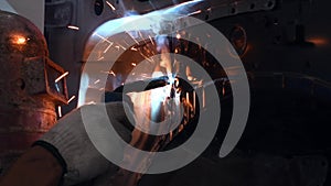 Welding steel with electricity in auto body repair shop, closeup