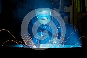 Welding a steel wheel with sparks spraying out