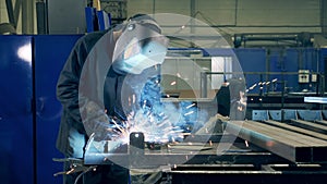 Welding technician is brazing pieces of metal. Professional Welder Working at factory facility.