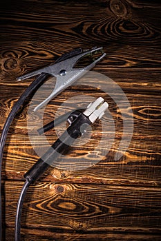 Welding wires on a wooden background. Place for the text. Studio photo in hard light