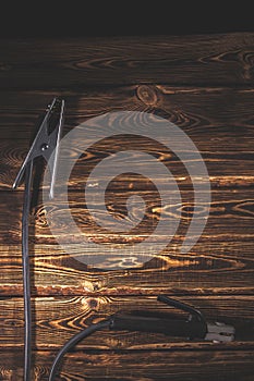 Welding wires on a wooden background. Place for the text. Studio photo in hard light