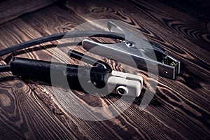 Welding wires on a wooden background. Studio photo in hard light