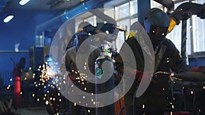 Welding work at the factory. Workers are engaged in gas welding. Factory work.