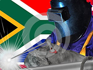 WELDING WORKER WITH THE SOUTH AFRICA FLAG IN THE BACKGROUND photo