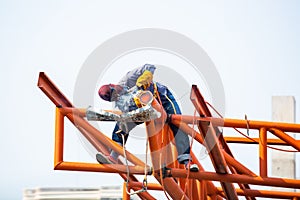 The welding workers at structures site. Worker is welding steel structures