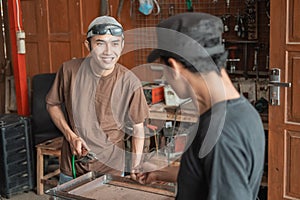 Welding workshop business owners tell their employees to complete work