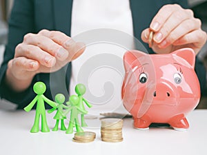 Welfare benefits concept. Woman`s hands stack some coins in a coin tower . Family welfare savings and insurance concept. Property photo