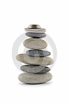 Welfare and Stability - stone stack with coins