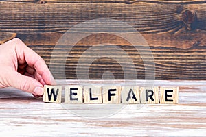 Welfare. Wooden letters on the office desk
